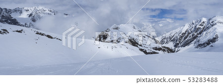 Panoramic view on winter mountain landscape at Stubai Gletscher ski area with snow covered peaks at 53283488