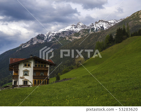Lush green meadow,Idyllic spring mountain rural landscape. View over Stubaital or Stubai Valley near 53283620