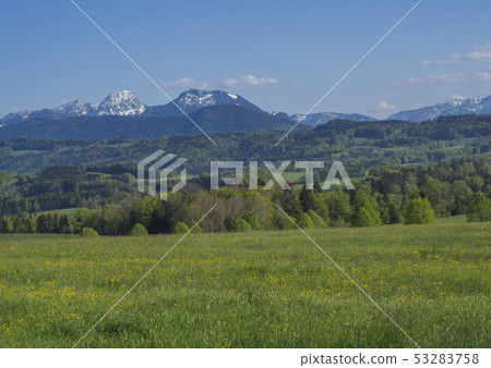 Beautiful spring rural mountain landscape in the Bavarian Alps with village and snow covered 53283758