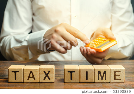 Wooden blocks with the word Tax time and taxpayer 53290889