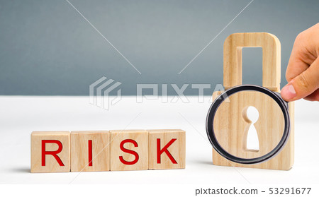 Wooden blocks with the word Risk and lock. 53291677