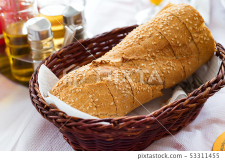 Greek traditional tsoureki slices in a wicker basket on a table in a restaurant Greek traditional tsoureki slices in a wicker basket on a table in a restaurant 53311455