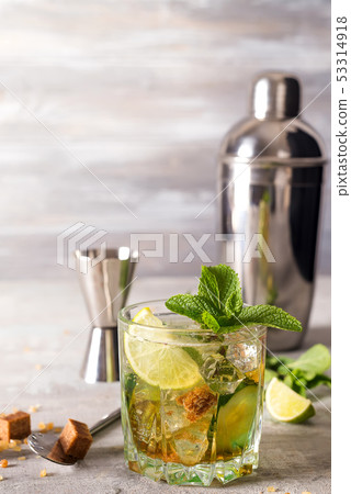 Mojito or Caipirinha cocktail. Brown sugar and an empty glass on stone 53314918