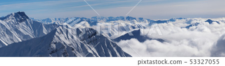 Panoramic view of snowy mountains covered with 53327055