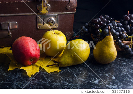 Cluster of blue grapes and ripe fruits on dark 53337316