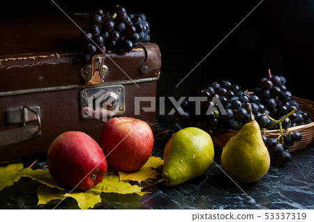 Cluster of blue grapes and ripe fruits on dark 53337319
