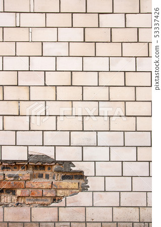 Old tiled wall with a broken red bricks. 53337426