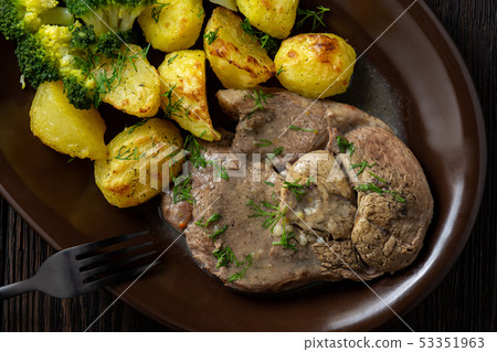 Slow roast leg of lamb with roasted potatoes. Slow roast leg of lamb with roasted potatoes. 53351963