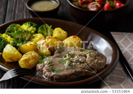 Slow roast leg of lamb with roasted potatoes. Slow roast leg of lamb with roasted potatoes. 53351964