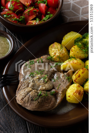 Slow roast leg of lamb with roasted potatoes. Slow roast leg of lamb with roasted potatoes. 53351969