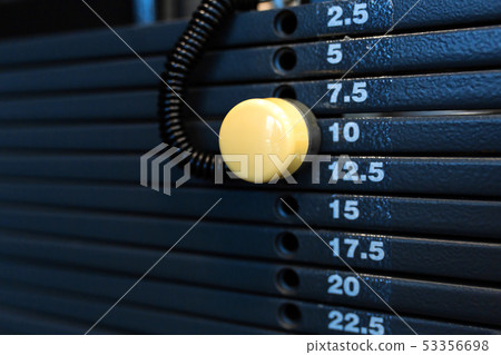 weight stack in a gym. Gym equipment weight stack in a gym. Gym equipment 53356698