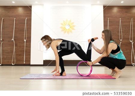 couple of young womans in a sportswear yoga couple of young womans in a sportswear yoga 53359030
