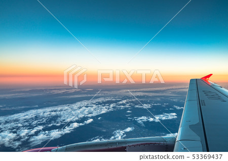 Sunrise view from the window of an airplane flying 53369437