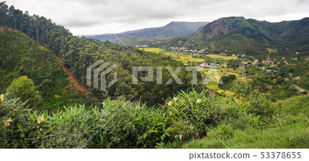 Typical Madagascar landscape at Mandraka region. Hills covered with green foliage, small villages in 53378655