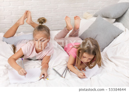 two little kids girls play in the bedroom two little kids girls play in the bedroom 53384644