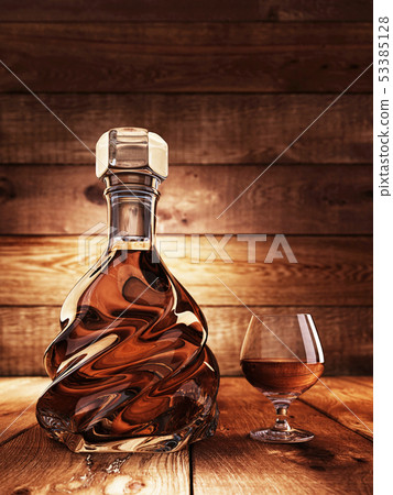 Cognac on a wooden table. 53385128