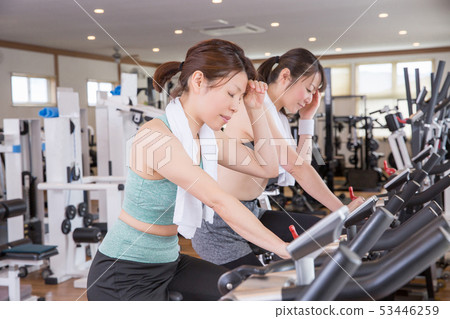 Woman doing aerobic exercise in a gym Woman doing aerobic exercise in a gym 53446259