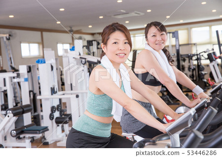 Woman doing aerobic exercise in a gym Woman doing aerobic exercise in a gym 53446286