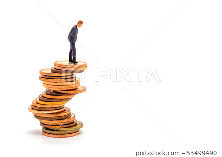 Miniature businessman on stack on white 53499490