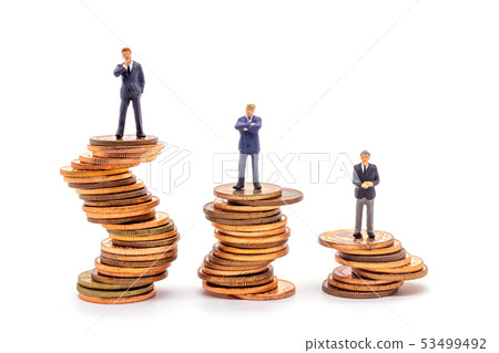 Miniature businessman on stack on white Miniature businessman on stack on white 53499492