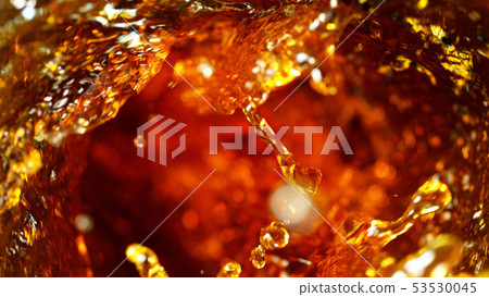 Detail of cola, tea or hard spirit beverages whirl 53530045