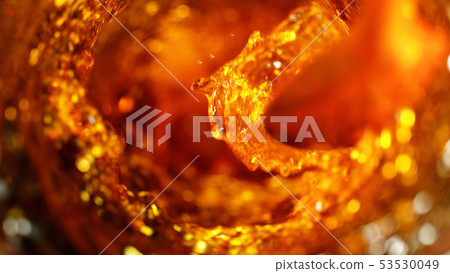 Detail of cola, tea or hard spirit beverages whirl 53530049