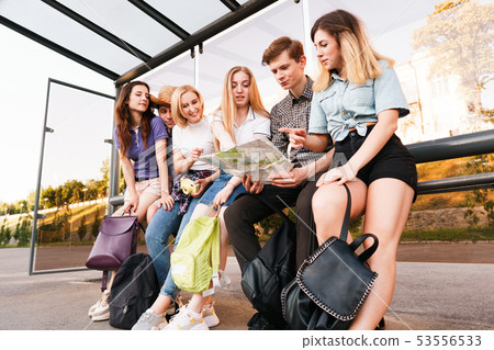 Tourists searching the location on city map Tourists searching the location on city map 53556533