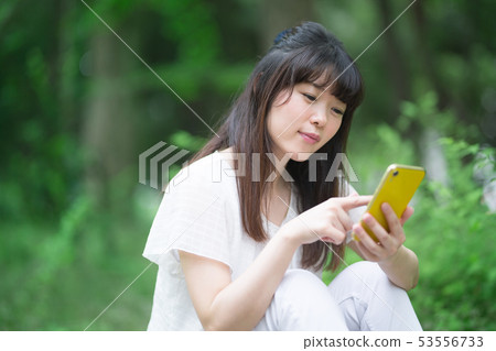 女人,新鮮的綠色,智能手機 女人,新鮮的綠色,智能手機 53556733