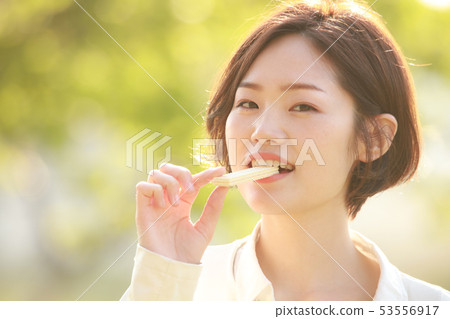 Woman eating wafer 53556917