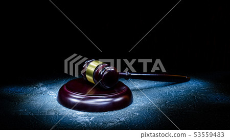 Judge's gavel lies on a stone table. Judge's gavel lies on a stone table. 53559483