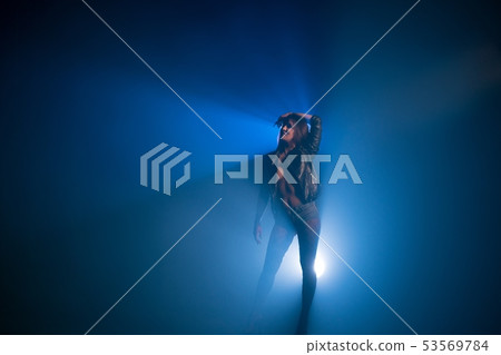Brunette wearing black jacket and jeans shorts Brunette wearing black jacket and jeans shorts 53569784