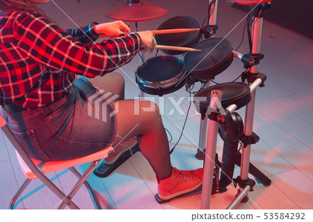 Rock, music and hobby concept - drummer's foot wears sneakers pushing drum bass pedal Rock, music and hobby concept - drummer's foot wears sneakers pushing drum bass pedal 53584292