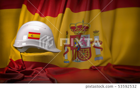 White hard hat laying over spanish  flag. 53592532