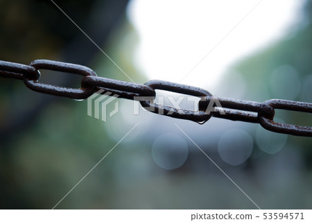 A rusty chain with sparkling water droplets A rusty chain with sparkling water droplets 53594571