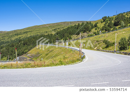 Road curves on a slope of the Pyrenees. Andorra 53594714