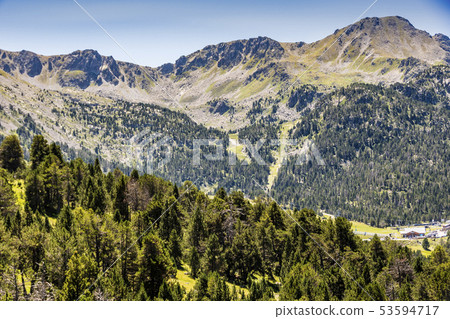 Pine forest and rocky peaks in the Pyrenees. Pine forest and rocky peaks in the Pyrenees. 53594717