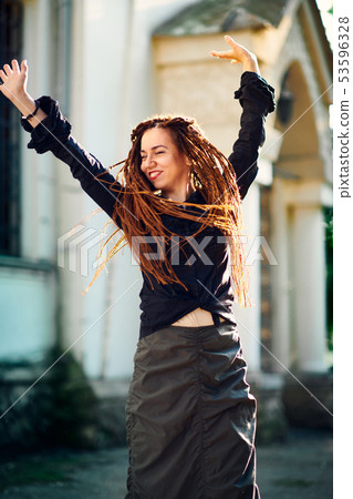 dreadlocks fashionable girl having fun and turns dreadlocks fashionable girl having fun and turns 53596328