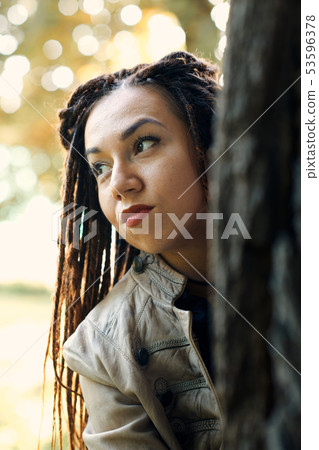 happy dreadlocks fashionable girl posing in forest happy dreadlocks fashionable girl posing in forest 53596378