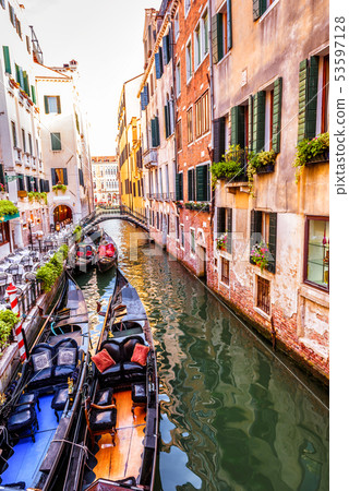 Street with moored gondolas and flowers, Venice, 53597128