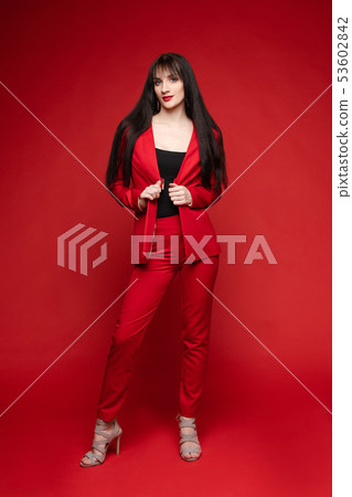Side view of glamorous brunette posing in red 53602842