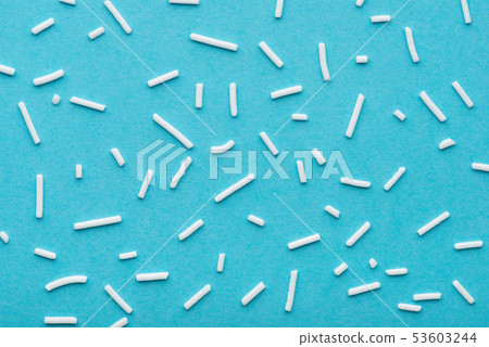 top view of white sprinkles over blue background, top view of white sprinkles over blue background, 53603244