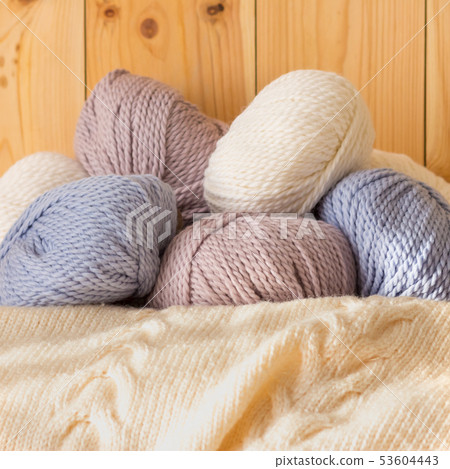 Thin fluffy skeins of wool for knitting a pale pink, blue and beige colors Thin fluffy skeins of wool for knitting a pale pink, blue and beige colors 53604443