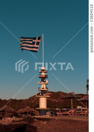 A Greek flag flying in Rhodes with a blue sky A Greek flag flying in Rhodes with a blue sky 53604518
