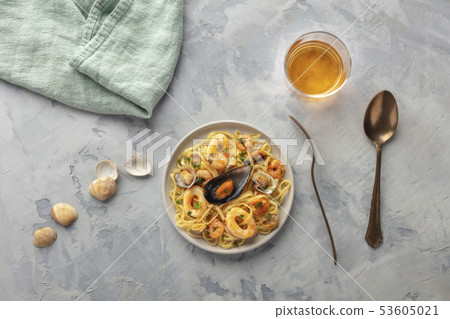 Seafood pasta. Tagliolini with mussels, shrimps, clams and squid rings, shot from the top with a Seafood pasta. Tagliolini with mussels, shrimps, clams and squid rings, shot from the top with a 53605021
