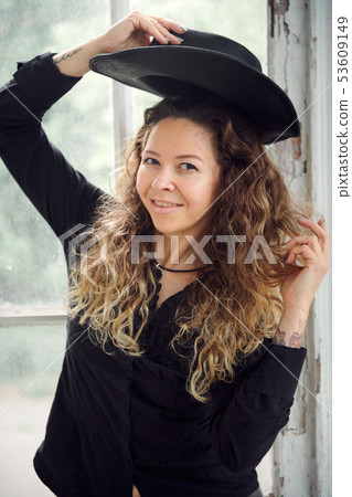 fashionable girl dressed in black shirt, hat and fashionable girl dressed in black shirt, hat and 53609149