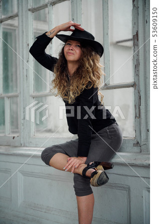 fashionable girl dressed in black shirt, hat and fashionable girl dressed in black shirt, hat and 53609150