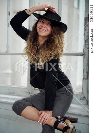 fashionable girl dressed in black shirt, hat and fashionable girl dressed in black shirt, hat and 53609151
