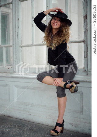 fashionable girl dressed in black shirt, hat and fashionable girl dressed in black shirt, hat and 53609152