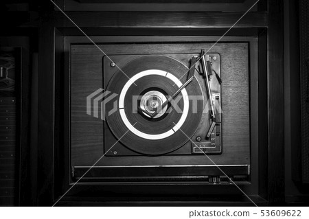 Top view of an old fashioned turntable playing a Top view of an old fashioned turntable playing a 53609622