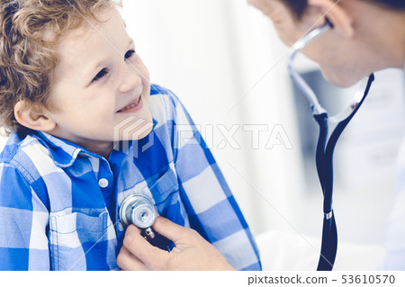 Doctor and patient child. Physician examining little boy. Regular medical visit in clinic. Medicine Doctor and patient child. Physician examining little boy. Regular medical visit in clinic. Medicine 53610570